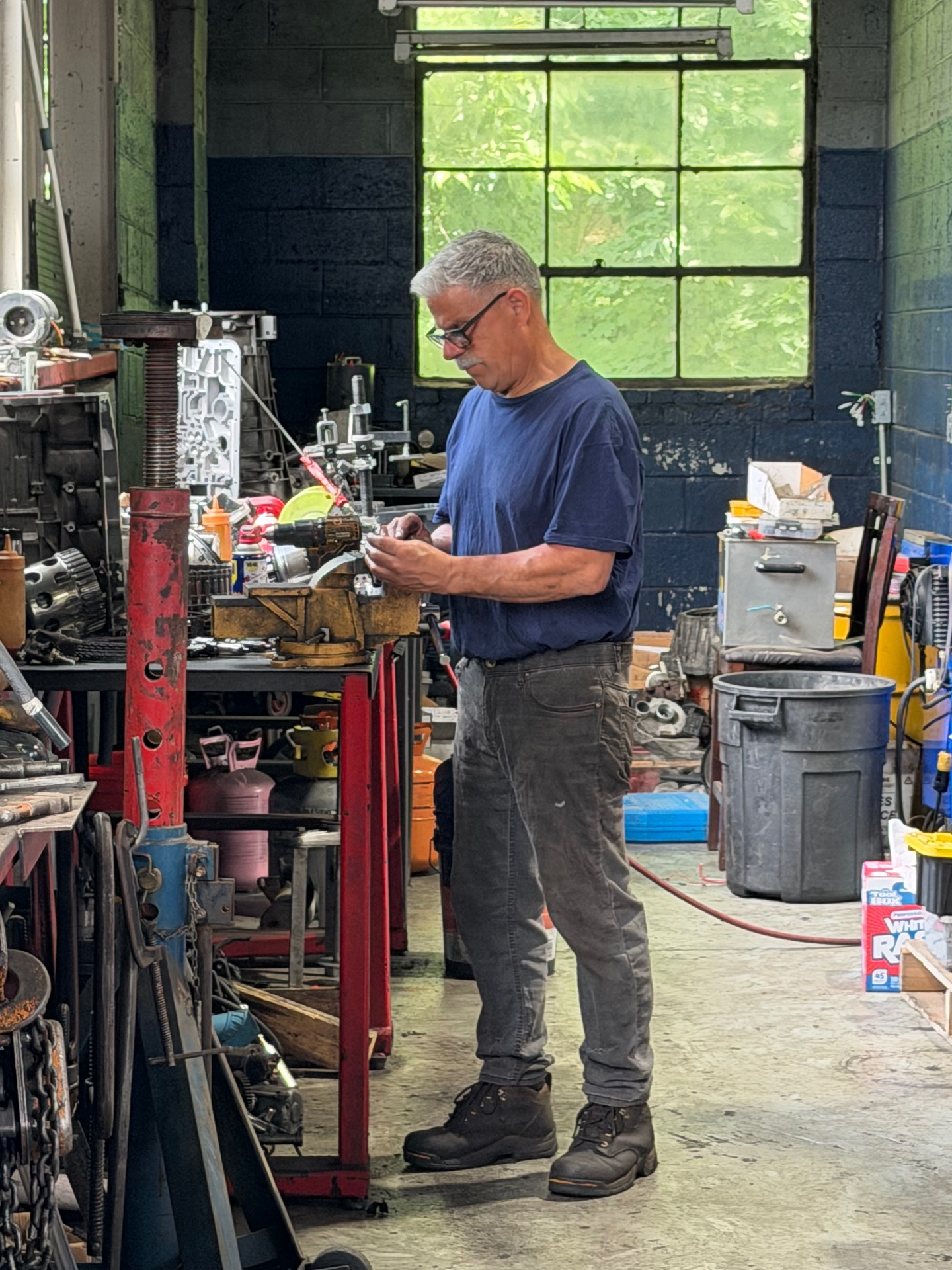 Technician working on a diesel component at the workbench inside the Staropoli Brothers shop